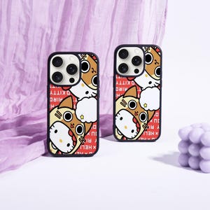 May include: Two black phone cases with a cartoon cat design. The cat is wearing a brown and yellow costume with a star. The background is red with white text that says "Hello Kitty".