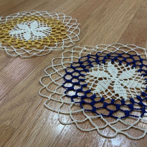 May include: A white ceramic mug with a black handle and the text "But First, Coffee" in a bold, black font. The mug is set against a neutral background, highlighting its simple design.