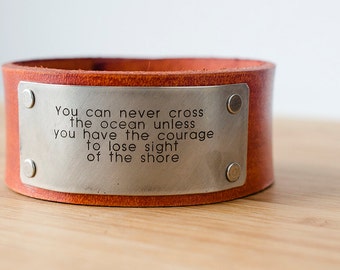 You can never cross the ocean unless you have the courage to lose sight of the shore - Custom Leather Cuff with Engraved Metal Plate