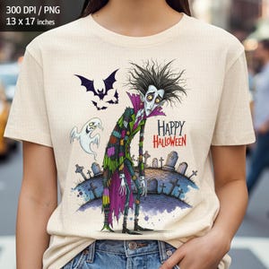 May include: Beige t-shirt with a cartoon vampire design, featuring wild black hair, a purple collar, and a patchwork coat. The design includes bats, a ghost, and the words "Happy Halloween" in red. This is a Halloween-themed garment.