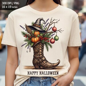 Pode incluir: Camiseta creme com um design temático de Halloween. O gráfico inclui um chapéu de bruxa, abóboras, uma vassoura e uma bota decorativa. O texto "HAPPY HALLOWEEN" é exibido abaixo. A camiseta tem aproximadamente 40.6 x 48.3 cm.