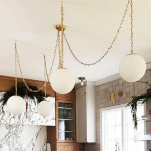 May include: A set of three ceramic mugs with a speckled, matte finish. The mugs are in shades of cream, light brown, and dark brown. Each mug has a simple, minimalist design, perfect for coffee or tea.