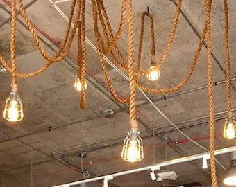 May include: The interior of a retail store with a wood-panelled wall, a variety of clothing racks, and a sign that reads "Uncle Dan's". The store has a rustic, outdoorsy feel with exposed beams and rope lighting.