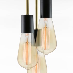 May include: A black and gold ceiling light fixture with three Edison bulbs. The fixture has a round black canopy and three black cylindrical shades.