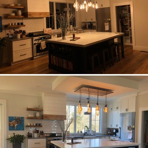 May include: A kitchen island with a white countertop and a dark blue base. The island has open shelving on the side and four metal bar stools. The island is lit by a rustic wood and metal chandelier with Edison bulb lights.
