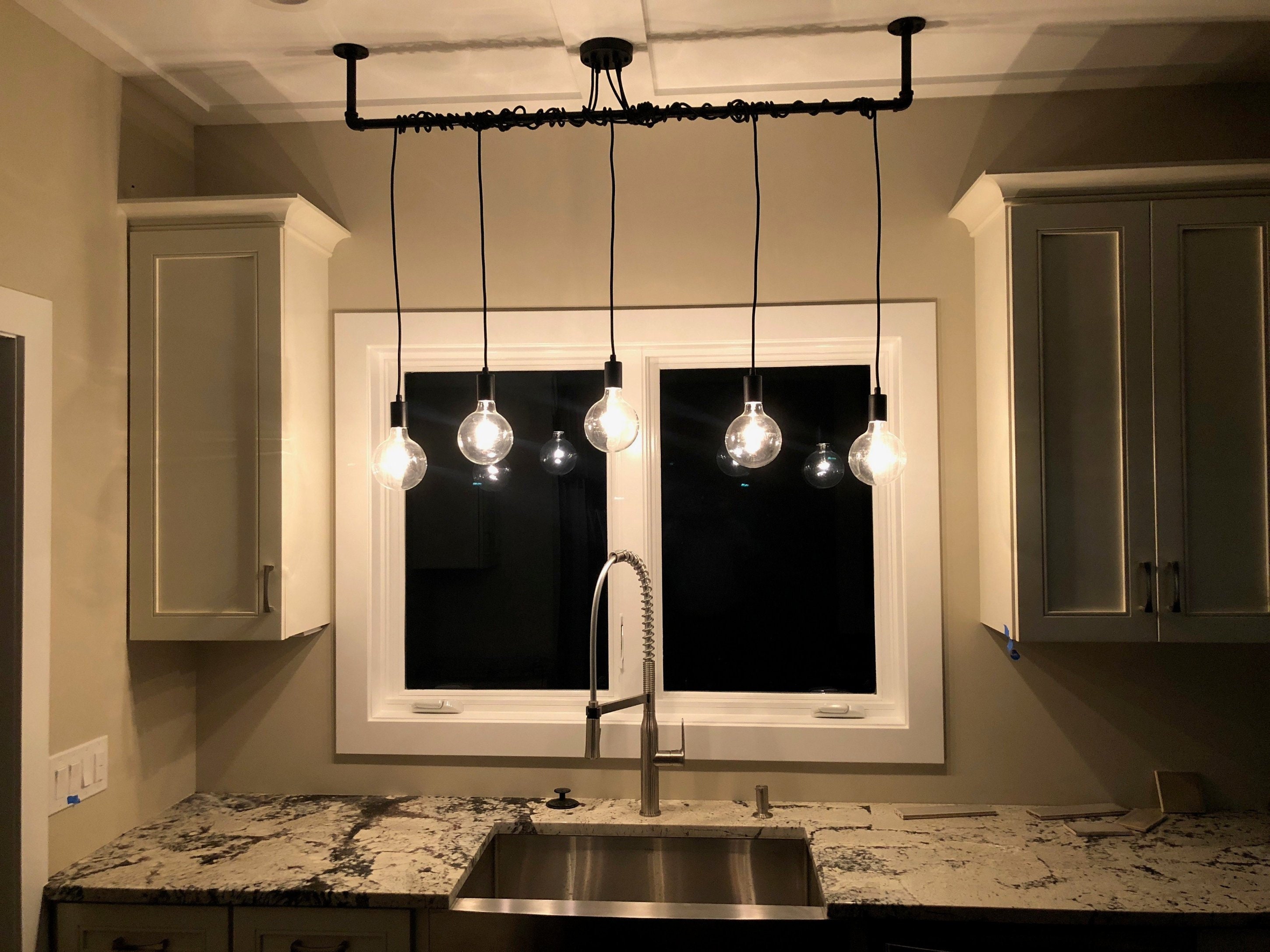 gray theme kitchen pendant light over kitchen sink