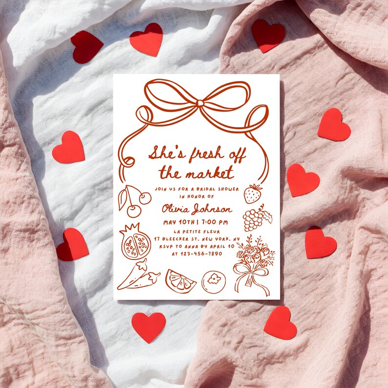 May include: A white bridal shower invitation with red text and illustrations of fruits and vegetables. The text reads "She's fresh off the market" and includes the bride's name, date, time, and location.