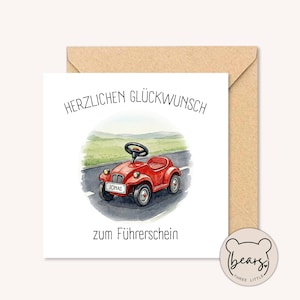 Könnte beinhalten: Eine Grußkarte mit einer Illustration eines roten Spielzeugautos. Das Auto hat ein schwarzes Lenkrad und den Namen "Jonas" auf der Vorderseite. Der Text "HERZLICHEN GLÜCKWUNSCH" und "zum Führerschein" ist in Schwarz geschrieben. Die Karte befindet sich in einem braunen Umschlag.