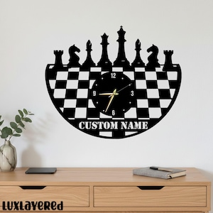 May include: Black and white chess-themed wall clock. The clock features a checkerboard pattern and silhouettes of chess pieces along the top. The clock face displays the numbers and hands. The text "CUSTOM NAME" is at the bottom.