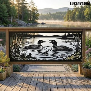 May include: A black metal decorative panel featuring a laser-cut design of two adult loons and two chicks swimming on a lake with cattails and water lilies. The text LUXLAYERED is visible in the upper right corner of the image.
