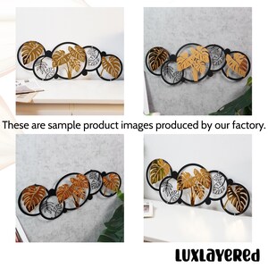 Pu&ograve; includere: Arte da parete in metallo decorativo con una serie di cerchi neri interconnessi con disegni di foglie tropicali dorate e argentate. Il testo "These are sample product images produced by our factory" &egrave; visibile.