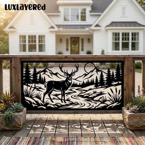May include: A black metal decorative panel featuring a laser-cut silhouette of a deer standing in a landscape with mountains, pine trees, a winding river, and a sun. The text LUXLAYERED is visible in the top left corner of the image.