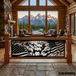 May include: A black metal railing insert featuring a silhouette of an elk standing in front of mountain peaks and a waving American flag. The design is framed by a rectangular border and is mounted within a wooden staircase railing structure.