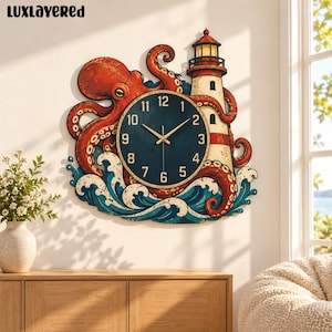 May include: A wall clock featuring a large orange octopus wrapping its tentacles around a white and red lighthouse, set against stylized blue ocean waves. The clock face is dark blue with gold numbers and hands. The text LUxLAYERED is visible.