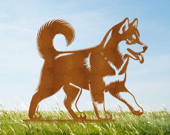 May include: A rusty brown metal sculpture of a dog, possibly a husky, walking across a grassy field. The dog has its tongue out and a curled tail. The sculpture is mounted on a horizontal base. The text "luxlayered" is visible in the lower right corner.