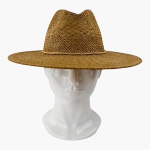 May include: A brown woven straw fedora hat with a wide brim and a pinched crown. The hat features a textured, braided pattern throughout the material and a thin, twisted cord band encircling the base of the crown, resting above the wide brim.