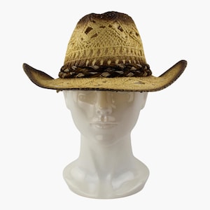 May include: A straw cowboy hat featuring a tan and brown ombre finish with an open-weave pattern. The hat includes a dark brown braided band around the base of the crown and a curved brim with a darker brown edge, displayed on a white mannequin head.