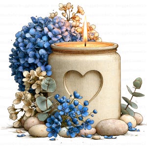 May include: A lit candle in a beige jar featuring a heart-shaped cutout, surrounded by clusters of blue hydrangea flowers, small white blossoms, green eucalyptus leaves, and smooth light-coloured river stones arranged at the base of the jar.