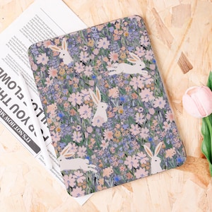 May include: Rectangular floral pattern with white rabbits. The design features a field of pink, blue, and yellow flowers on a dark background. White rabbits are scattered throughout the design, some in motion.