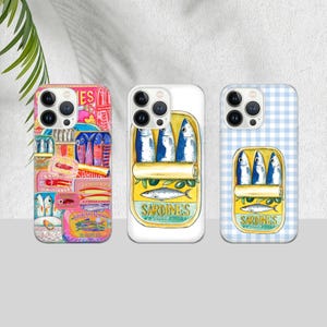 May include: Three phone cases with sardine can designs. One case has a collage of sardine can labels in pinks, blues, and yellows. The other two cases feature a sardine can illustration with blue fish and the text "Sardines". One case has a white background, and the other has a blue gingham pattern.