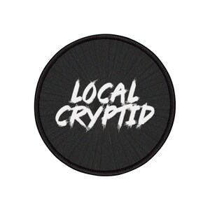 Lokal kryptid rund tygtryckt stryklapp