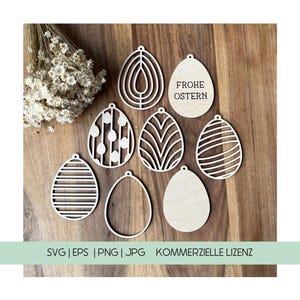 Puede incluir: Un conjunto de ocho recortes de huevos de Pascua de madera con varios diseños, que incluyen rayas, lunares y patrones geométricos. Un recorte presenta el texto "Frohe Ostern" en alemán, que se traduce como "Feliz Pascua".