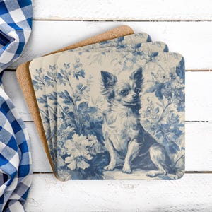 May include: Set of four square coasters featuring a blue and white floral design with a Chihuahua illustration. The coasters have a cork backing and a cream-colored background. The design is reminiscent of classic toile.