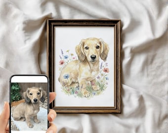 May include: A framed watercolor print of a long-haired dachshund puppy. The artwork features the dog sitting in a field of wildflowers in shades of blue, pink, and yellow. The frame is a dark brown color.
