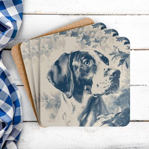 May include: Set of four square coasters featuring a blue and white illustration of a dog's head. The dog is a Pointer breed, with a detailed depiction of its face and fur. The background has a floral pattern.