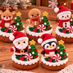 May include: Five crocheted Christmas ornaments featuring a reindeer, gingerbread person, snowman, Santa Claus, and penguin. Each figure sits on a brown base with a green tree, red and white peppermint candy, and red berries.