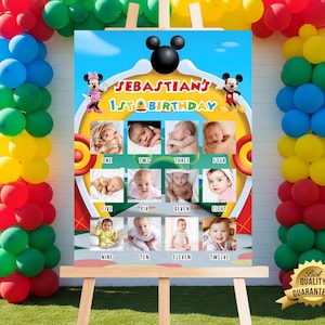 May include: A colorful birthday sign featuring Mickey Mouse and Minnie Mouse characters. The sign displays the text "Sebastian's 1st Birthday" and includes photos of a baby from one to twelve months old. The sign is on an easel.