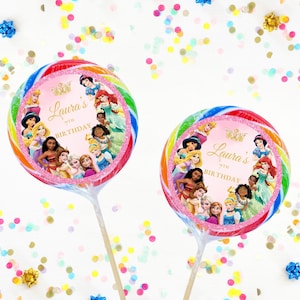 May include: A pink and rainbow swirl lollipop with a picture of Disney princesses and the text "Laura's 7th Birthday".
