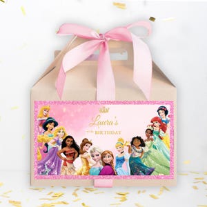May include: A brown paper favor bag with a pink ribbon and a sticker featuring Disney princesses. The sticker says "Laura's 7th Birthday".