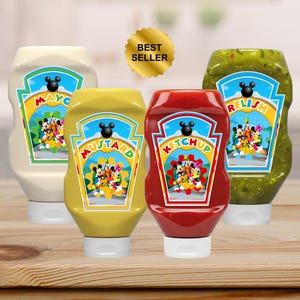 May include: Four condiment bottles: mayonnaise, mustard, ketchup, and relish. Each bottle has a label with the product name and a cartoon character design. The bottles are on a wooden surface, with a "Best Seller" sticker.