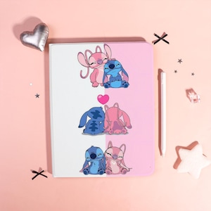 May include: A tablet case with illustrations of Stitch and Angel from Lilo & Stitch. The case is split into white and pink halves, showcasing three different images of the characters in affectionate poses. A pink heart is also visible.
