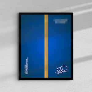 May include: A framed print featuring a blue background with two vertical yellow stripes. The print includes text and a signature in white. The frame is black.