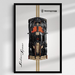 May include: A framed poster featuring a top-down view of a black and tan sports car model with orange interior details. The car is centered on a light gray background with two vertical tan stripes. The text "SedarsSpear" is printed in black.