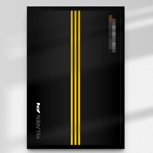 May include: Black framed art print featuring two vertical yellow stripes down the center. The McLaren P1 logo is in white on the left side. The artwork has a minimalist design.