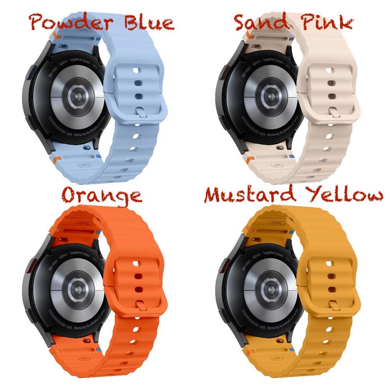 May include: Four smartwatches with coloured bands: powder blue, sand pink, orange, and mustard yellow. Each watch has a black face and a matching silicone band. The watch bands are ribbed and have a buckle closure.
