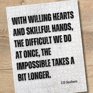 May include: A white background with black text that reads "With willing hearts and skillful hands, the difficult we do at once, the impossible takes a bit longer." The text is centered on the page and is in a bold font. The text is followed by the words "US Seabees" in a smaller font.