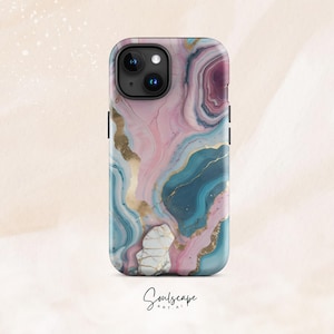 May include: A phone case with a pink, blue, and gold marble design. The case has a cutout for the camera lens.