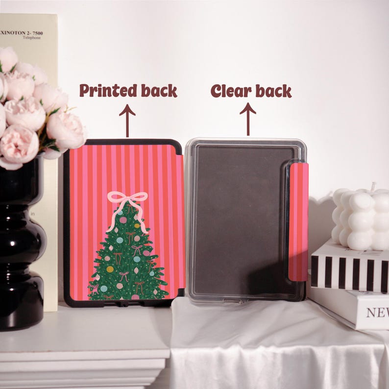 May include: A tablet case with a printed back and a clear back. The printed back features a Christmas tree design on a pink striped background. The clear back is transparent with a pink accent.