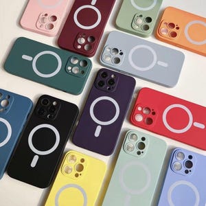 May include: Assortment of phone cases in various colors with a built-in magnetic ring holder. The cases are made of silicone and have a raised camera bump for added protection.