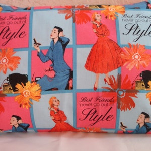 May include: A pink and blue pillow with a checkered pattern and floral designs. The pillow has the text "Best Friends never go out of Style" repeated on it.