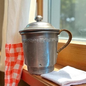 May include: A set of three ceramic mugs with a speckled, matte finish. The mugs are in shades of cream, light gray, and dark gray. Each mug has a simple, minimalist design, perfect for coffee or tea.