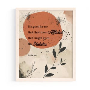 May include: Framed art print with a neutral color palette. The artwork features an abstract design with a large orange circle and botanical elements. Text from Psalm 119:71 is displayed in a stylish font.