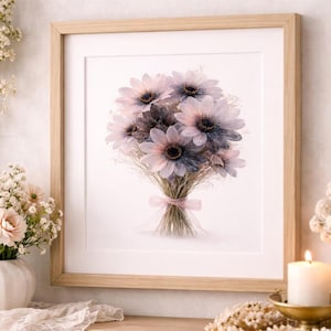 May include: A framed print featuring a bouquet of pastel-colored flowers. The flowers have pink and purple petals with dark centers, tied with a pink ribbon. The frame is made of light-colored wood, and the background is white.