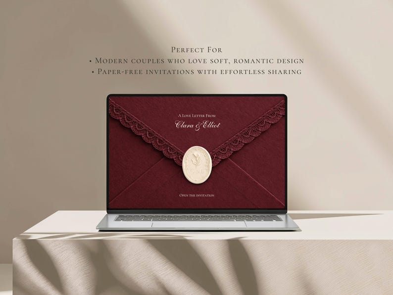 May include: A laptop screen displaying a digital invitation featuring a deep red envelope with a lace trim and a cream-colored wax seal. The text reads: A LOVE LETTER FROM Clara & Elliot, and OPEN THE INVITATION. Above the laptop, text reads: PERFECT FOR MODERN COUPLES WHO LOVE SOFT, ROMANTIC DESIGN and PAPER-FREE INVITATIONS WITH EFFORTLESS SHARING.