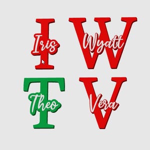 May include: Four wooden letter cutouts in red and green, each with a name in a cursive font. The letters are I, W, T, and V, with the names Iris, Wyatt, Theo, and Vera. The names are in white with a red or green outline.