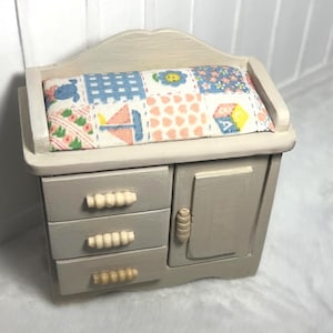 May include: A set of three ceramic mugs with a speckled, matte finish. The mugs are in shades of cream, light gray, and dark gray. Each mug has a simple, minimalist design, perfect for coffee or tea.